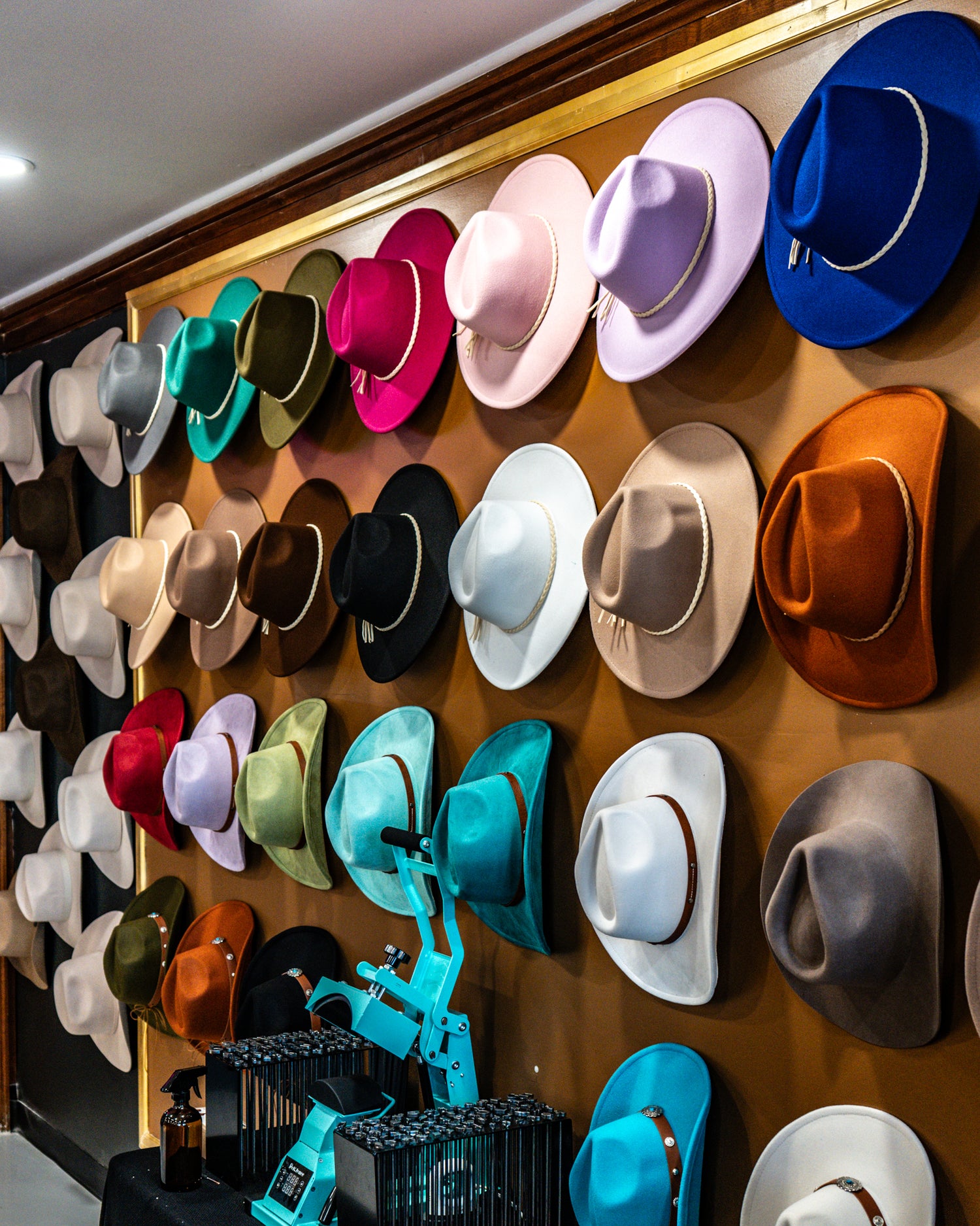 Wall display of colorful hats in various sizes and colors.